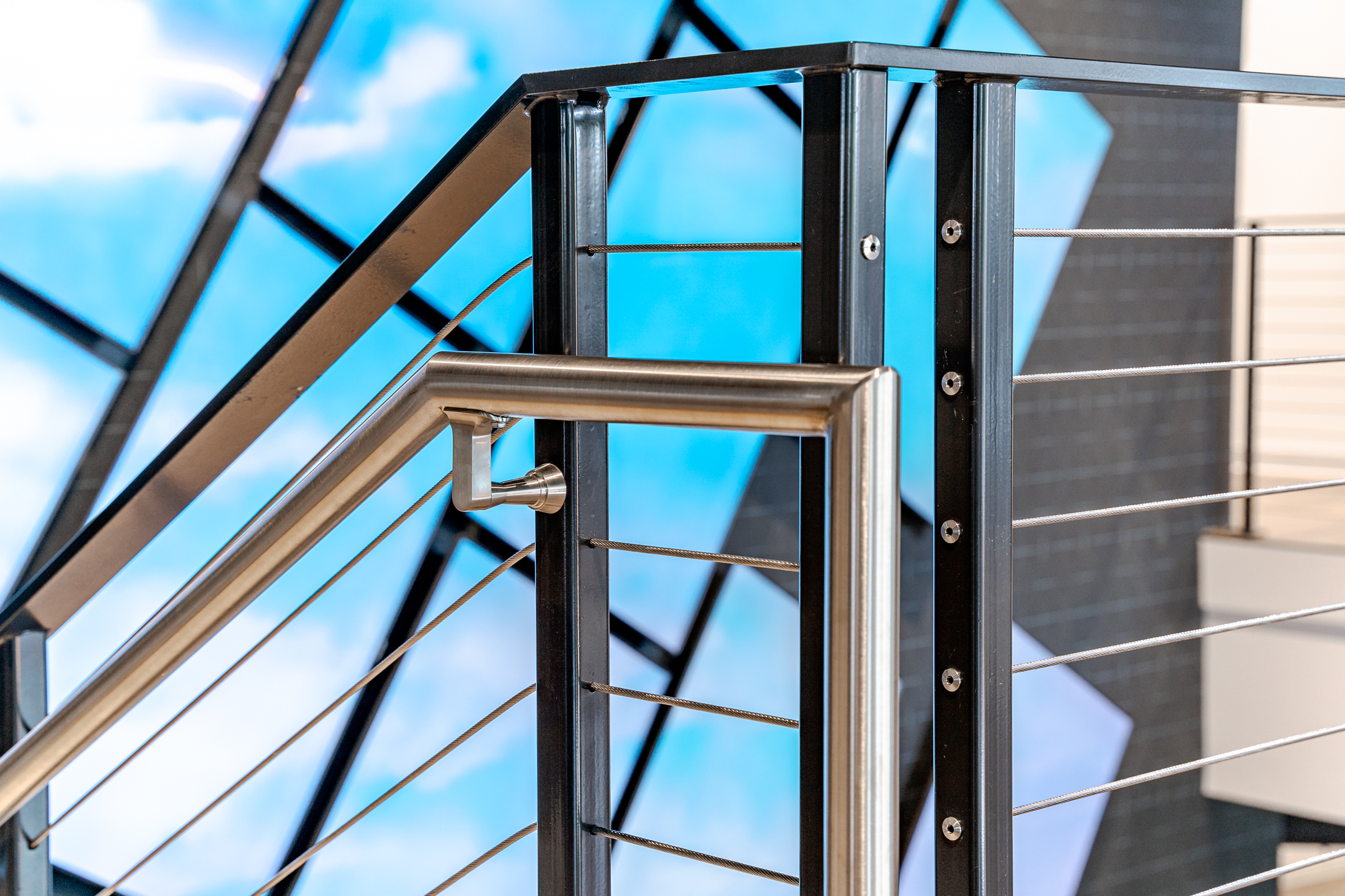 Close up view of architectural railings with stainless steel handrail.