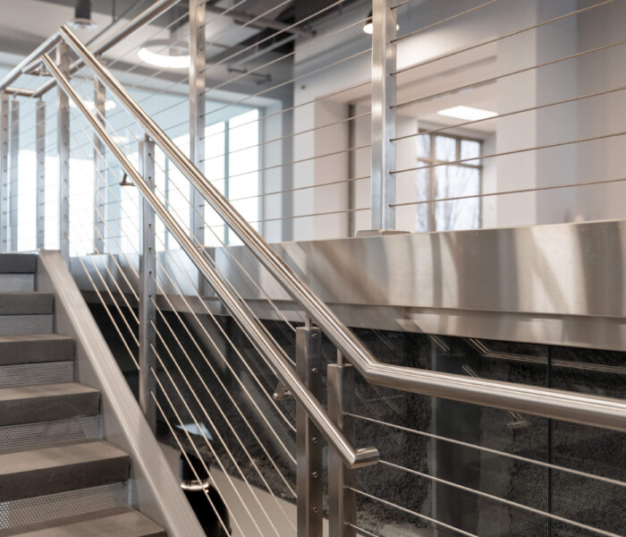 A view of a commercial building with new architectural railings with assist rail.