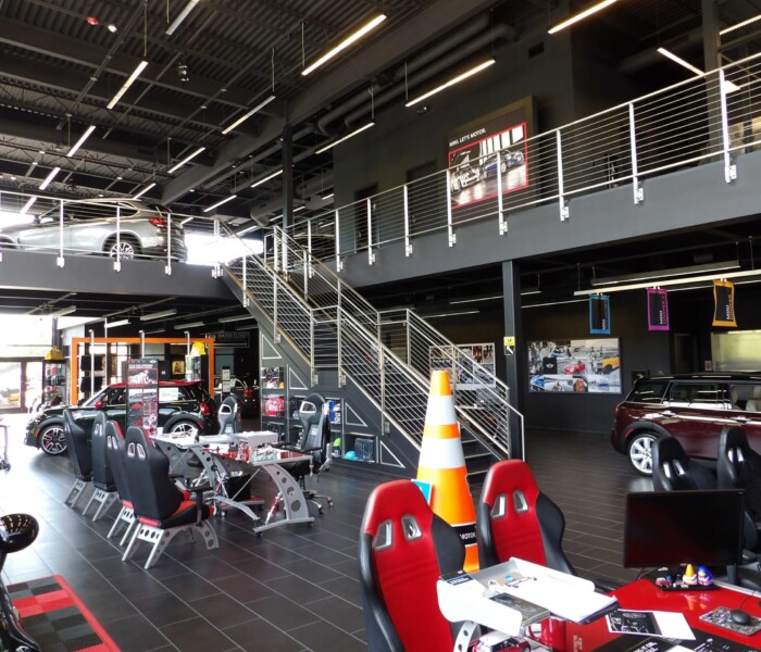 Architectural Railings with cars and black commercial building.